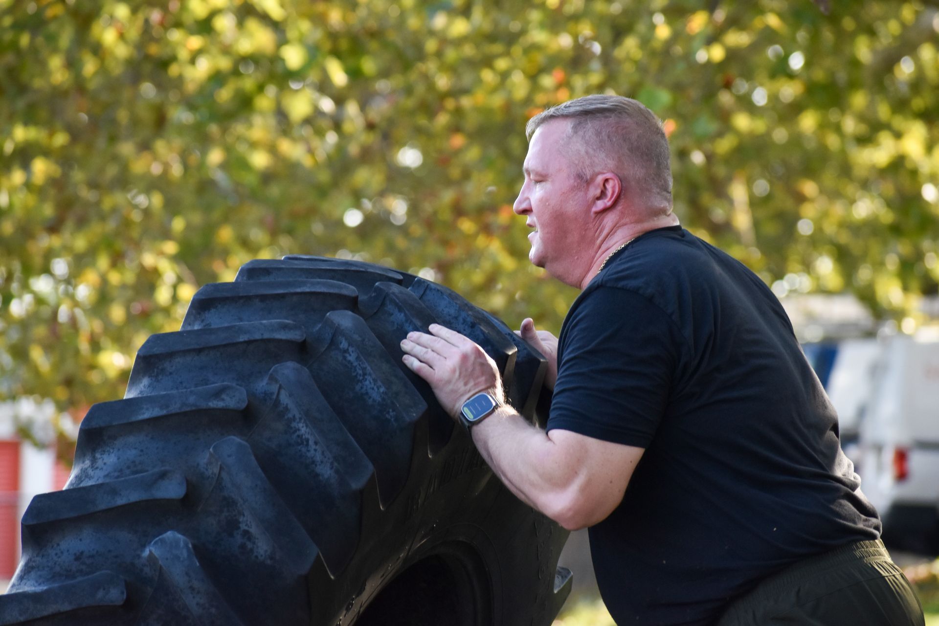 Member flipping a tire outside