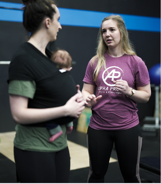 A woman wearing a purple shirt with the letter p on it