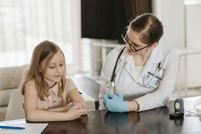 A pediatrician is talking to a young girl