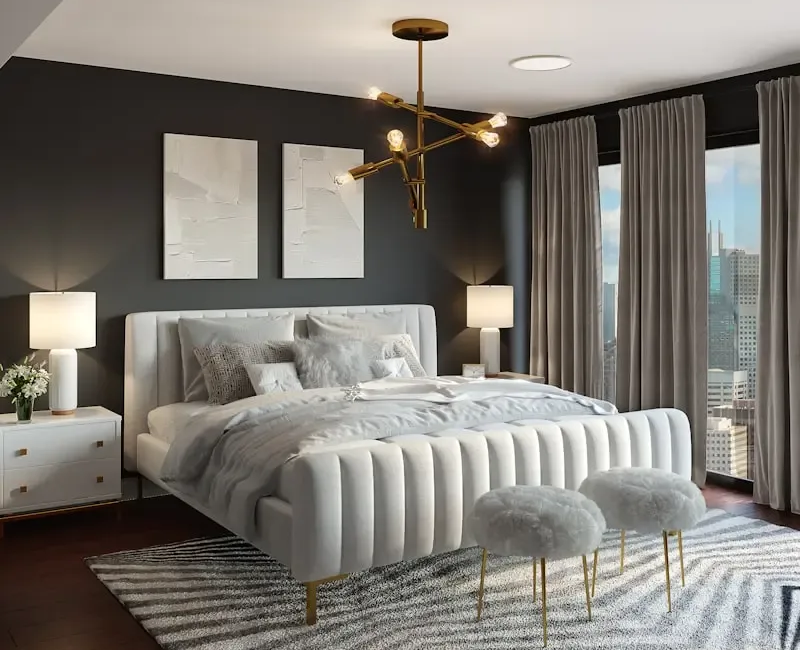 Modern bedroom with tufted white bed, brass chandelier, gray walls, and floor-to-ceiling curtains.