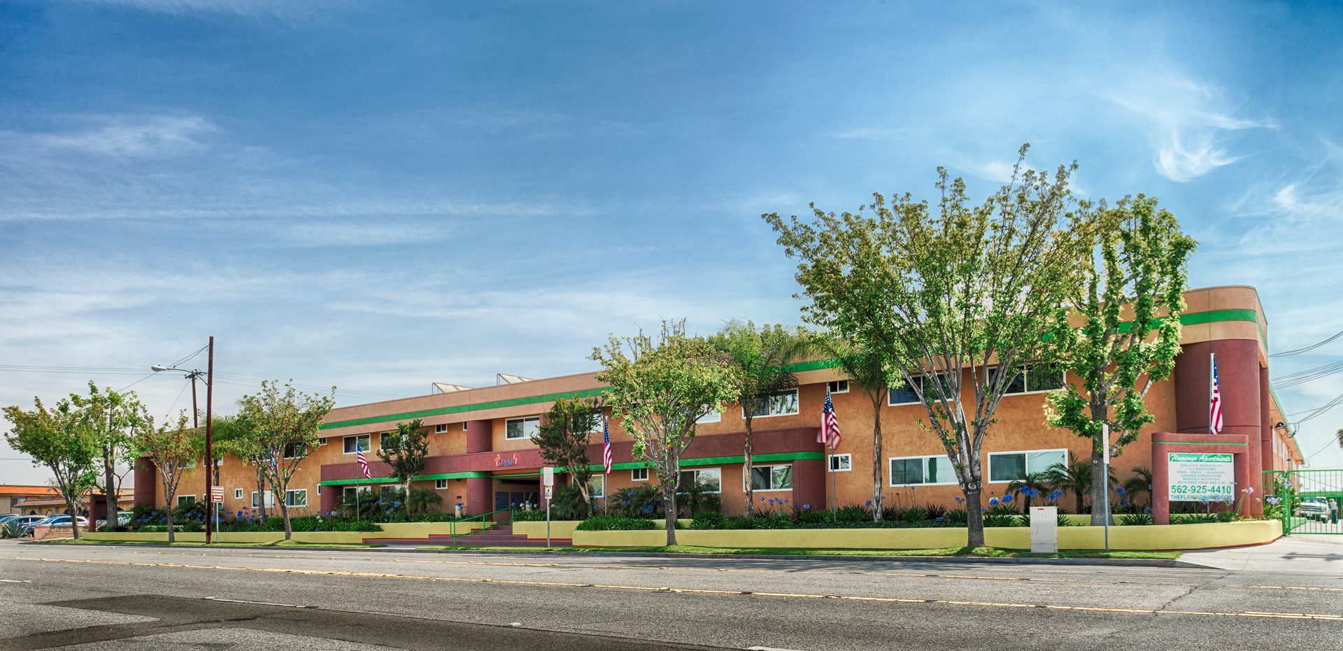 A large building with a lot of windows and trees in front of it.