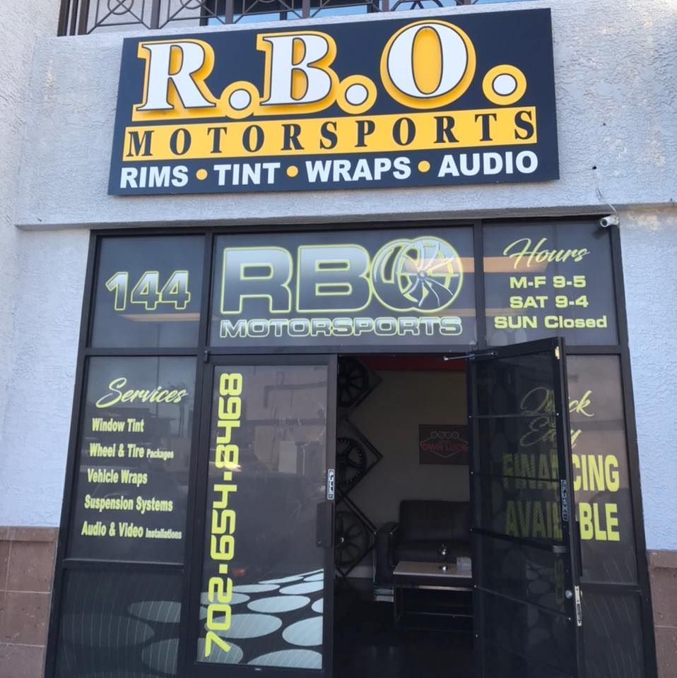 R.B. Motorsports storefront with black-and-gold signage advertising rims, tint, wraps, and audio