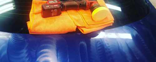 red polished on a microfiber towel on a blue car with compound swirls