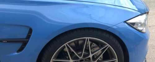 detailed front end of a blue BMW