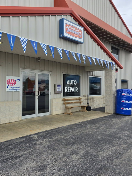 Auto repair shop with white and red exterior, sign