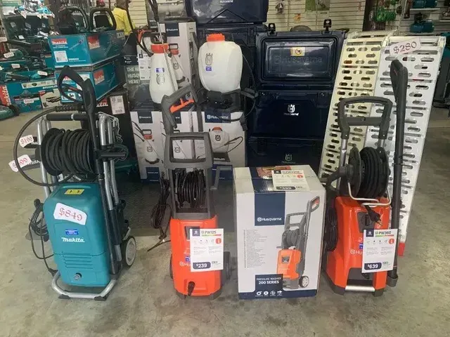 Cureved Loading Ramps, Chainsaw And Oil Products on the Shop Shelves — Gloucester Outdoor Solutions In Gloucester, NSW