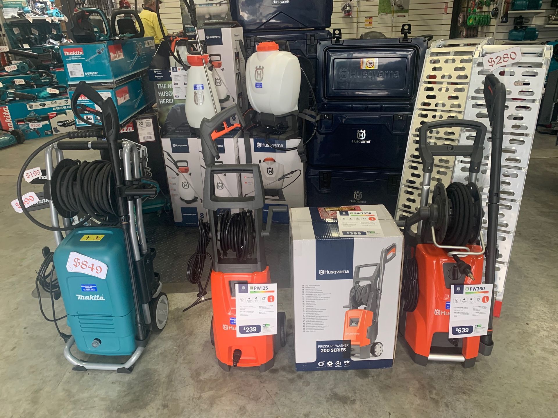 Assortment of pressure washers, sprayers, and related outdoor power equipment displayed in a hardware store — Gloucester Outdoor Solutions In Bulahdelah, NSW