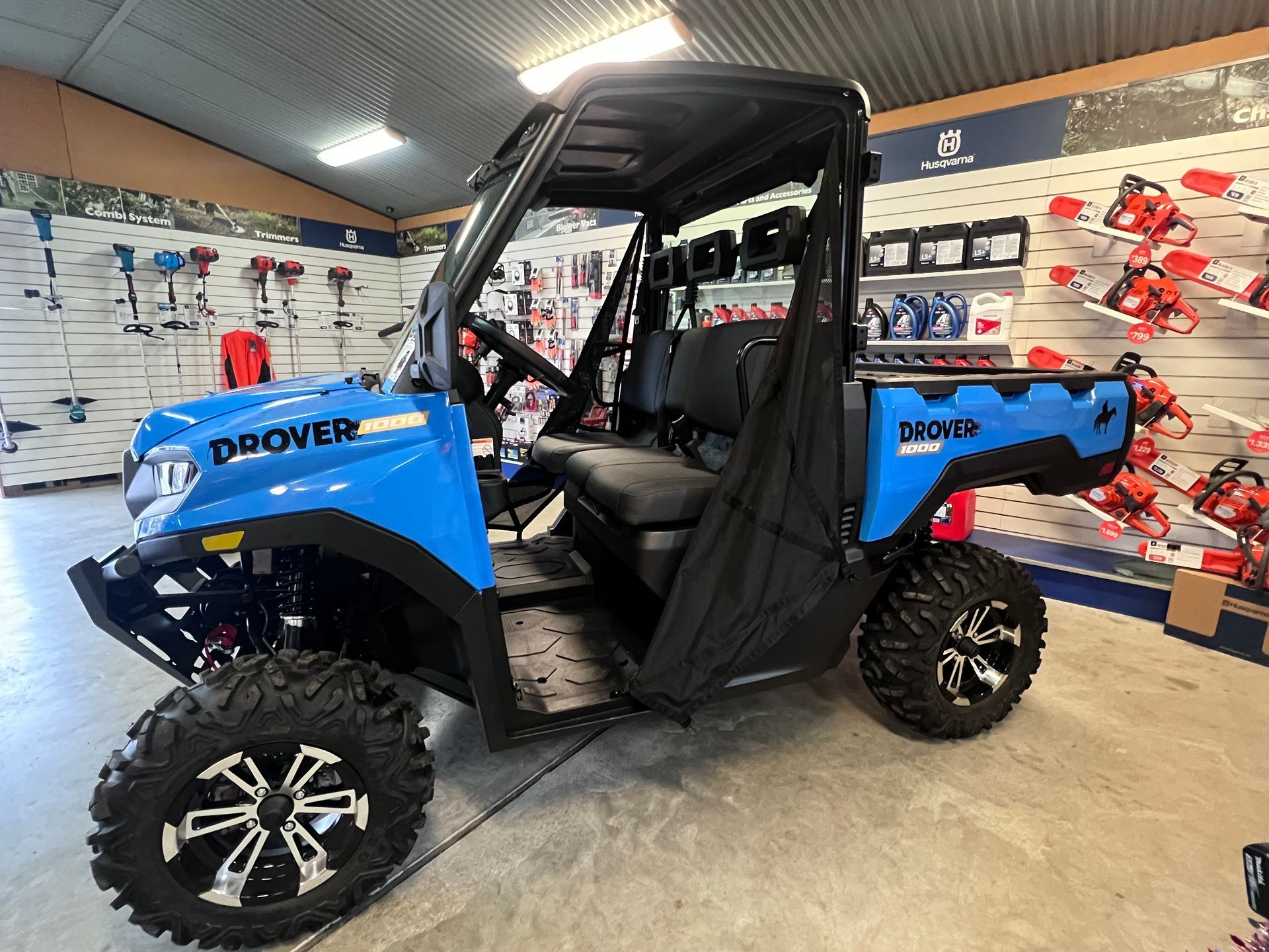 Blue Side-by-side Utility Vehicle With Black Accents Displayed Inside a Store — Gloucester Outdoor Solutions In Gloucester, NSW