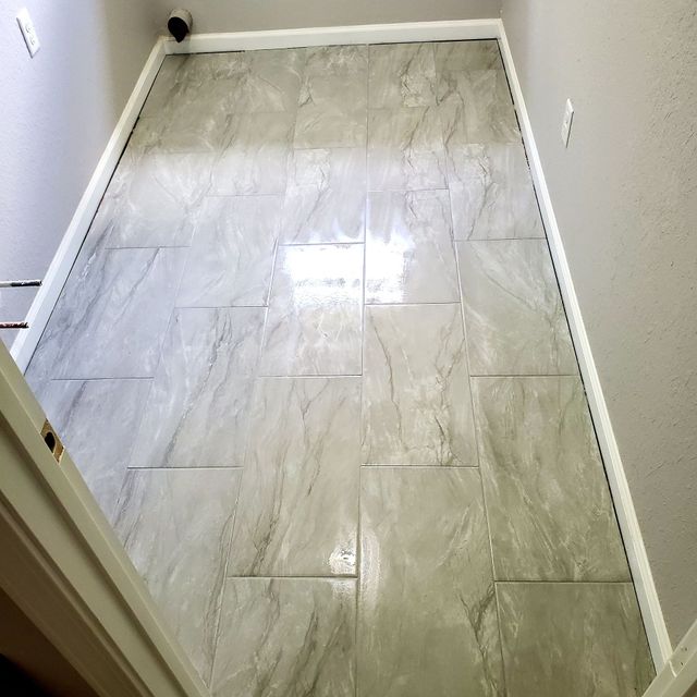 A room with a tiled floor and white trim