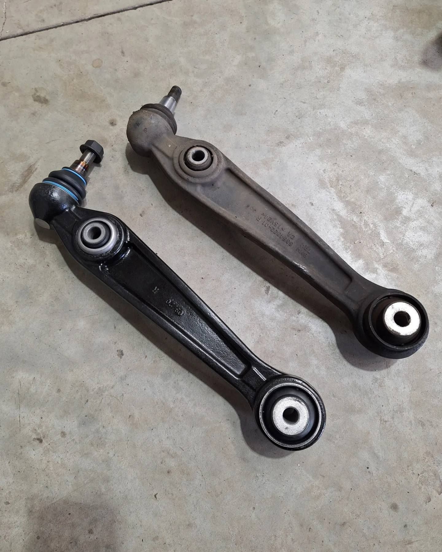 Two arms are sitting on a concrete surface.