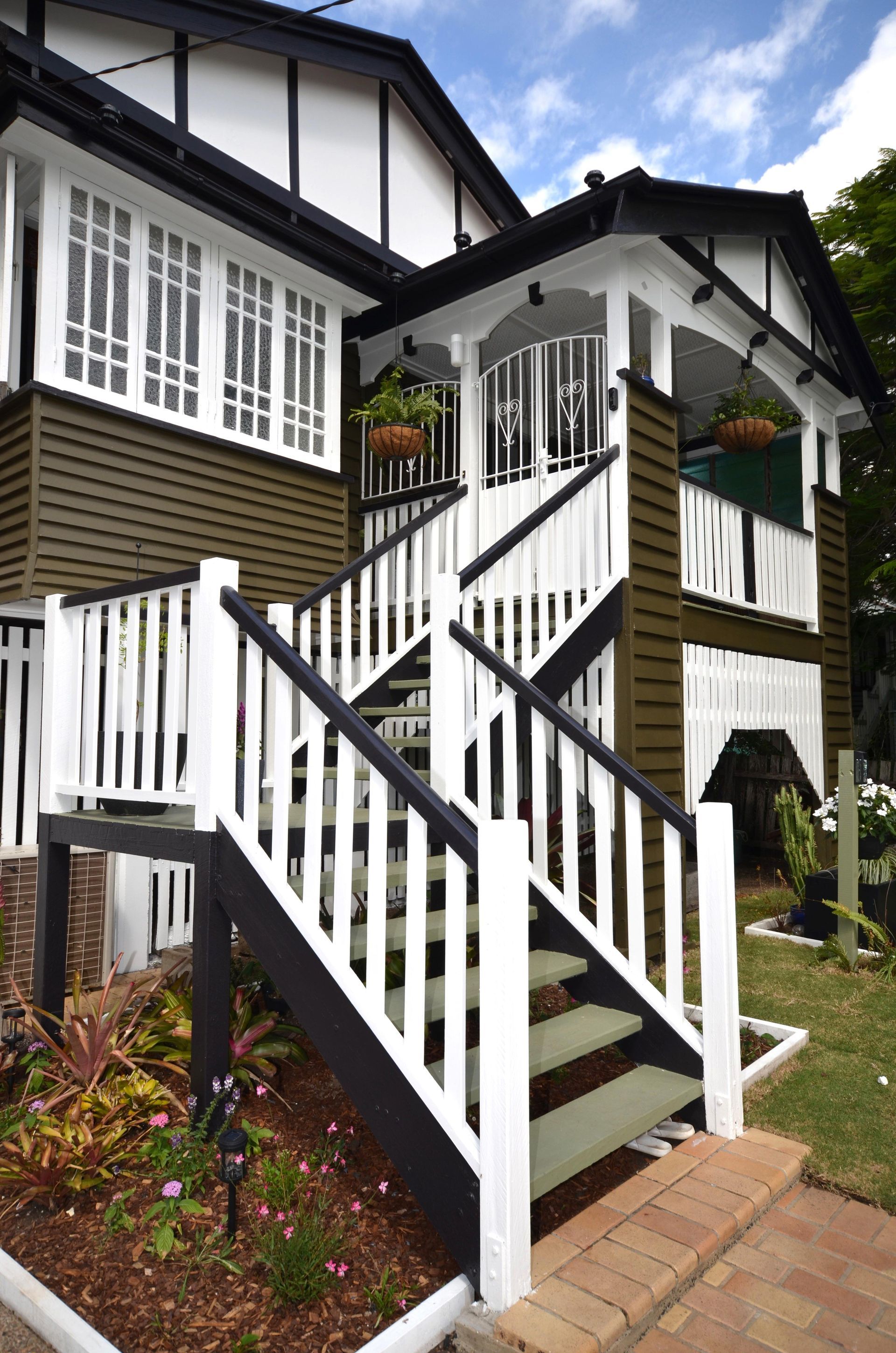 A black and white house with stairs leading up to it — Ipswich, QLD — S & D Painters