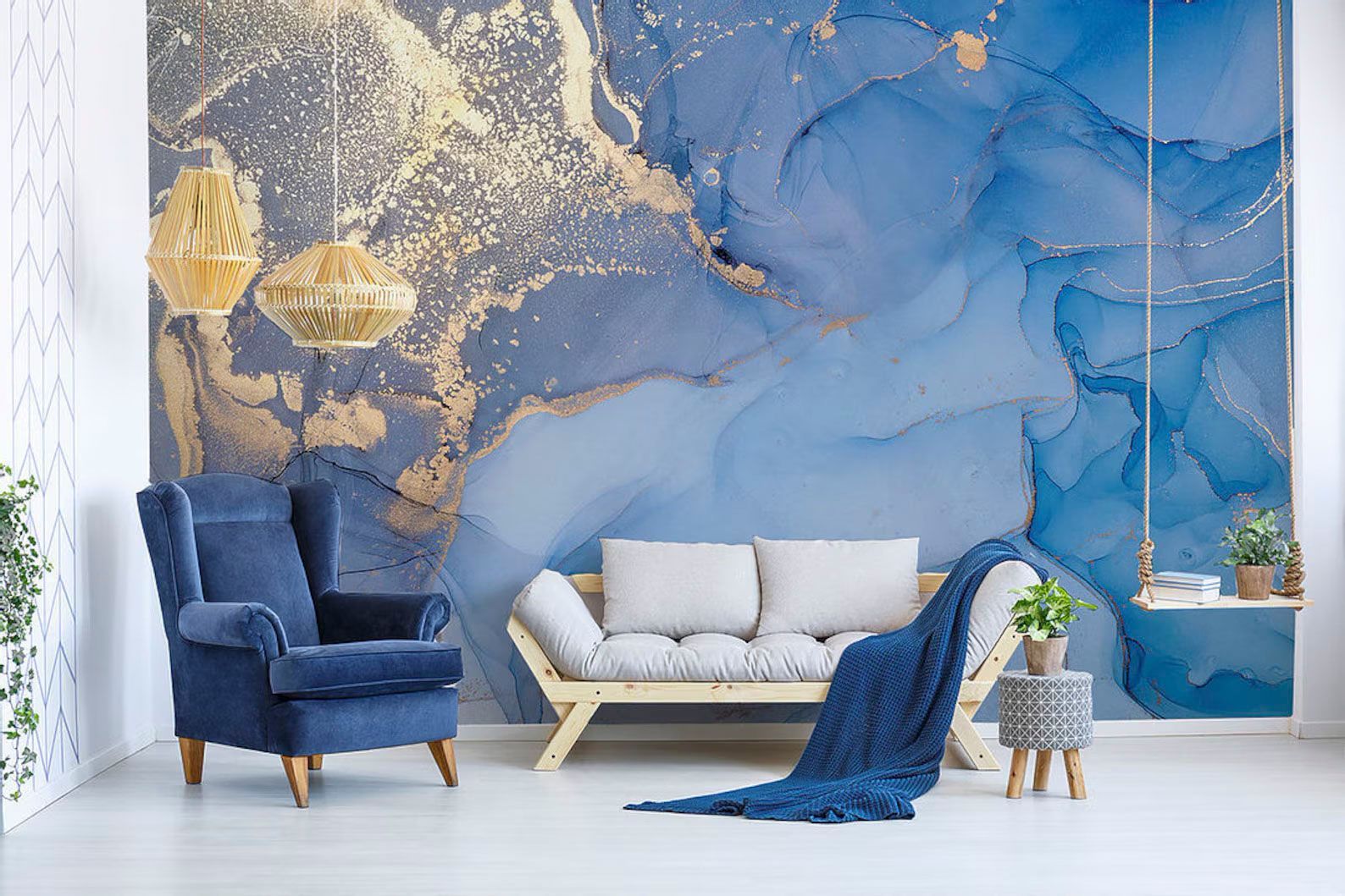 A living room with a couch , chair , and a blue wall mural.
