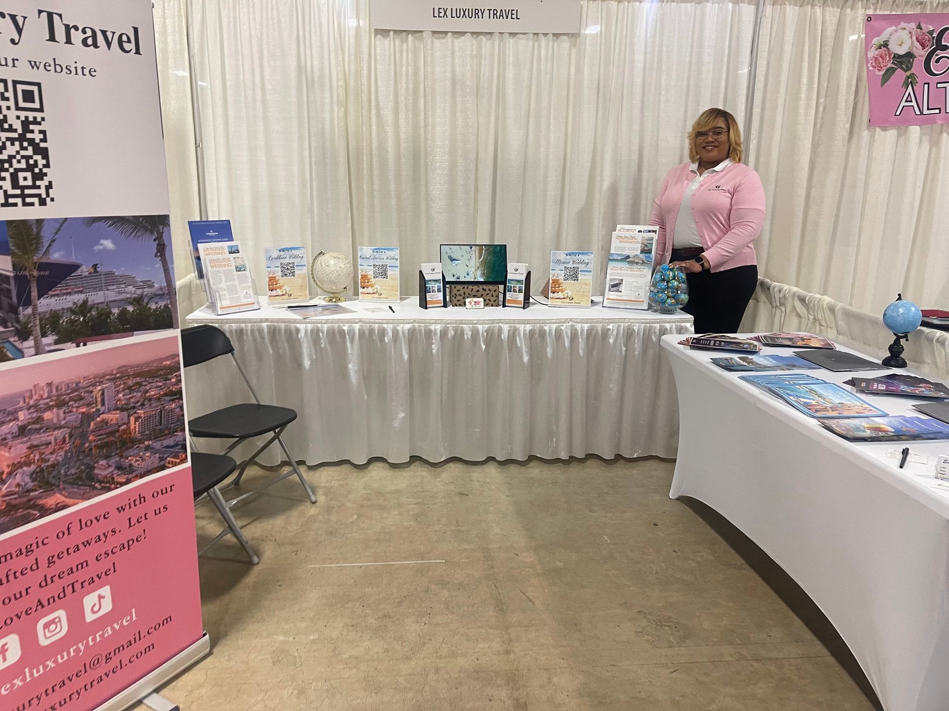 Lex Luxury Travel booth showcasing travel planning services at a local event