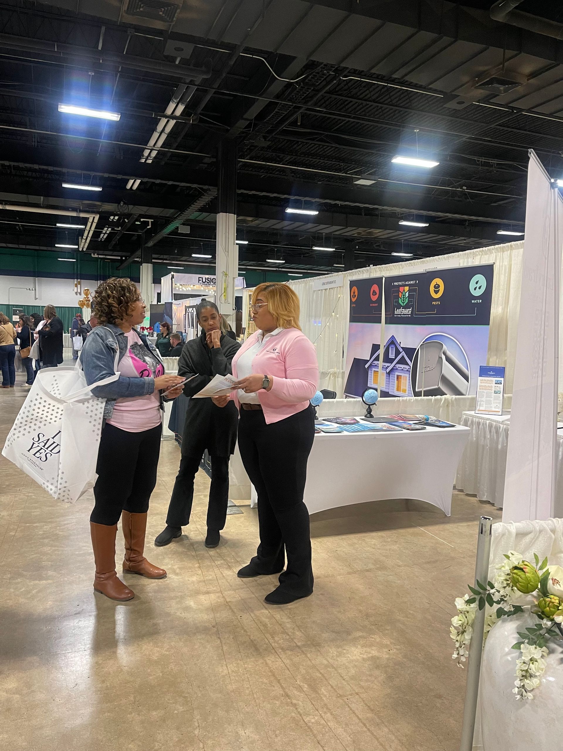Lex Luxury Travel team engaging with attendees to discuss travel planning and deals