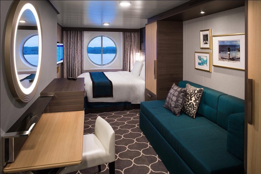 Oceanview cruise cabin with seating area for Super Cruise 2026 guests