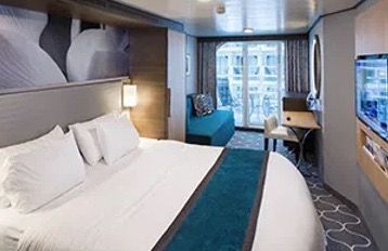 Balcony cruise cabin bedroom with modern amenities for Super Cruise 2026