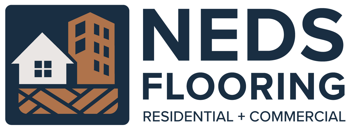 The logo for ned 's flooring shows a city skyline with houses on the roofs.