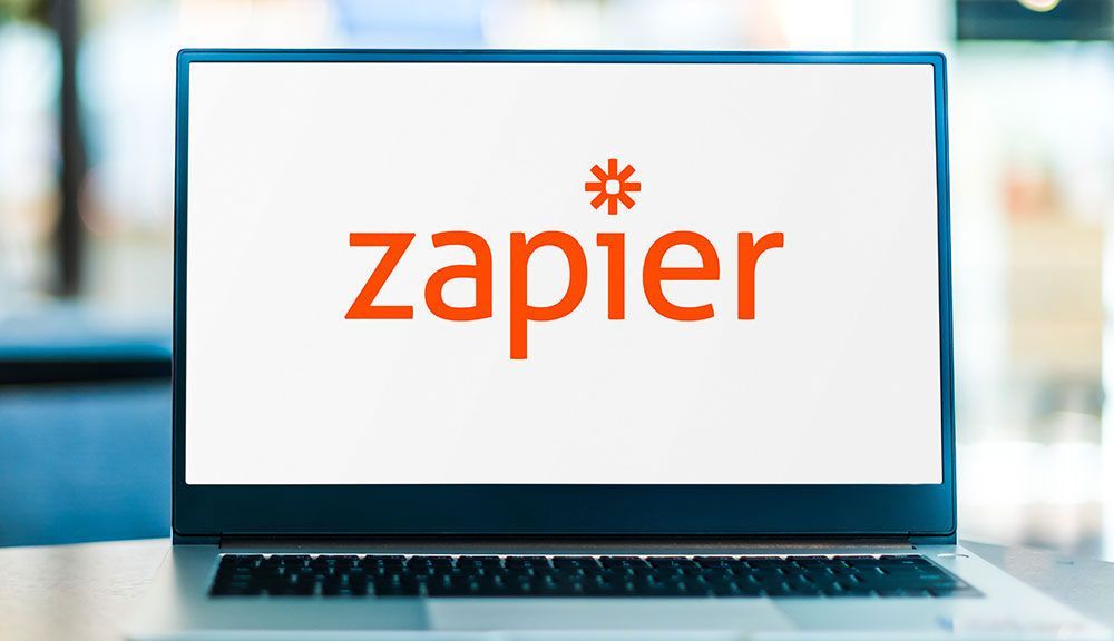 Zapier logo on a laptop screen in a modern office setting