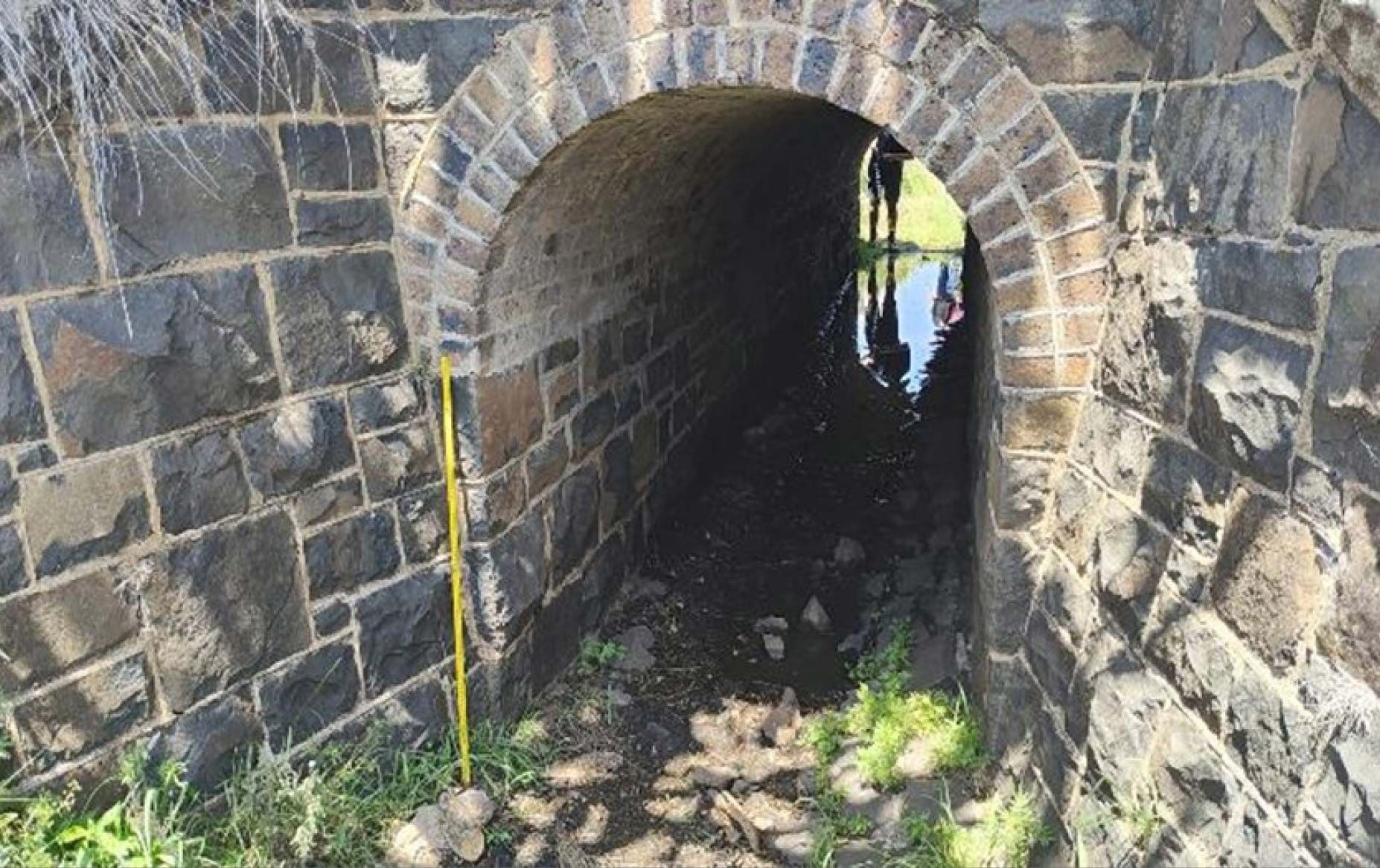 Redleaf Group was engaged by RMA Engineers to conduct a detailed cultural heritage assessment of the Charlton Stone Culvert, constructed ca. 1860s, beneath a decommissioned railway embankment at Charlton, Queensland. The assessment was performed in line with the Queensland Heritage Act 1992 and the Australia ICOMOS Burra Charter (2013) and included onsite inspections, structural and condition analysis, comparative heritage evaluation, and legislative compliance review. The stone culvert is a rare and intact example of early railway infrastructure, comprising bluestone blocks, brick arch roof, and convict-picked sandstone finishes, possibly associated with Queensland’s first chief railway engineer, Abraham Fitzgibbon.