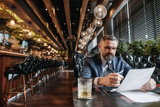 Hospitality executive reviewing documents in a restaurant