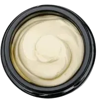 Jar of light yellow cream, swirled in a black container.