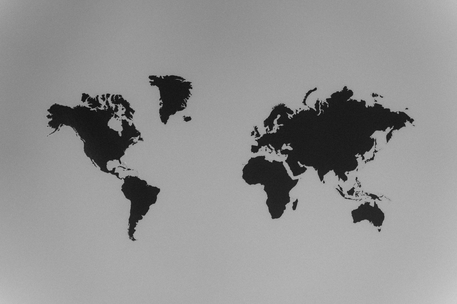 World map outlines in black on a gray background.