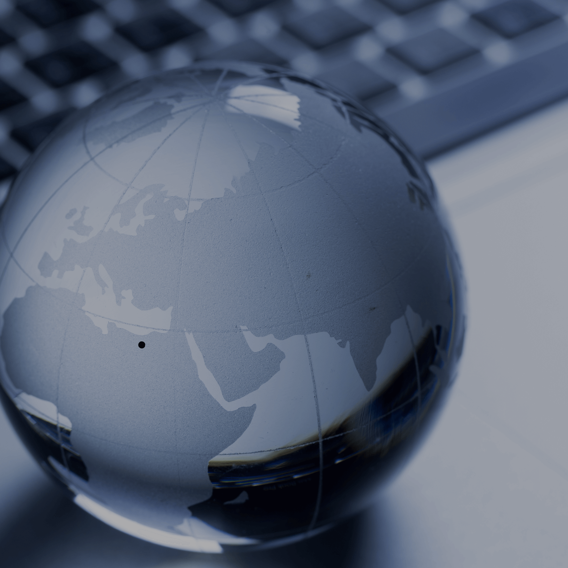 Abstract globe on a keyboard, symbolizing Gym Revival Group's vision for global strategic backbone.