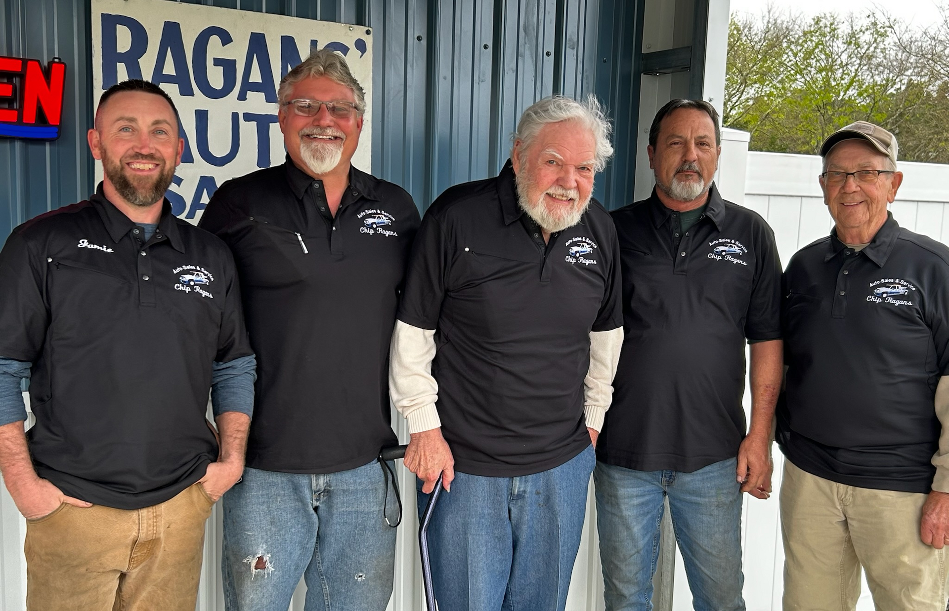 Five men in black shirts pose in front of Ragan's Auto Sales | Chip Ragans Auto, LLC