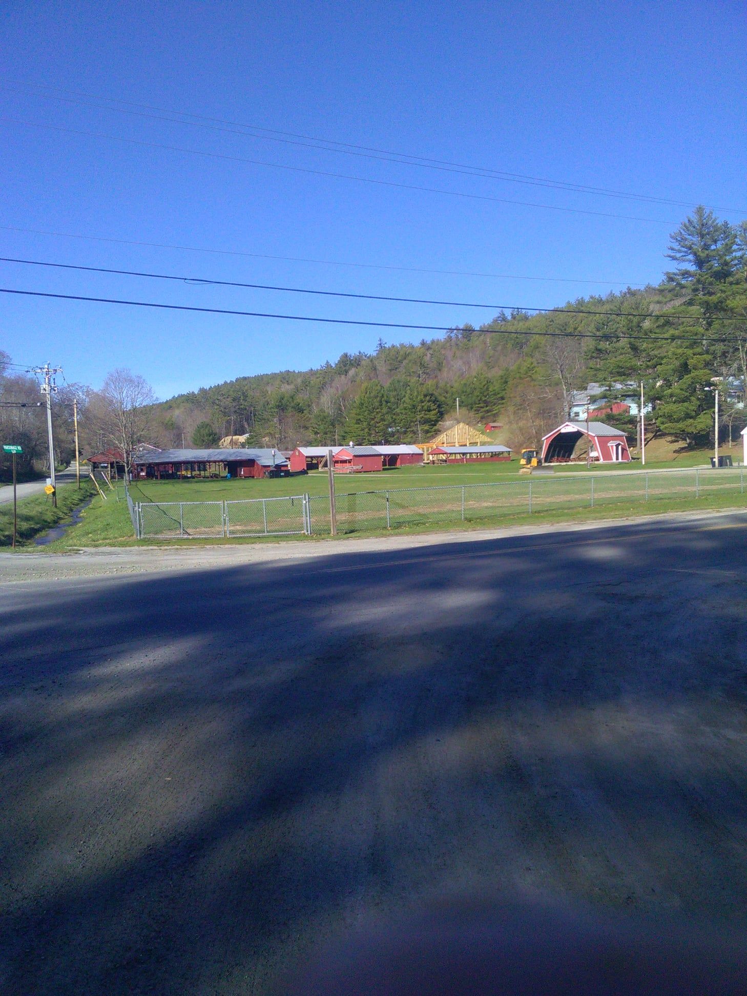 A view of a farm from the side of a road