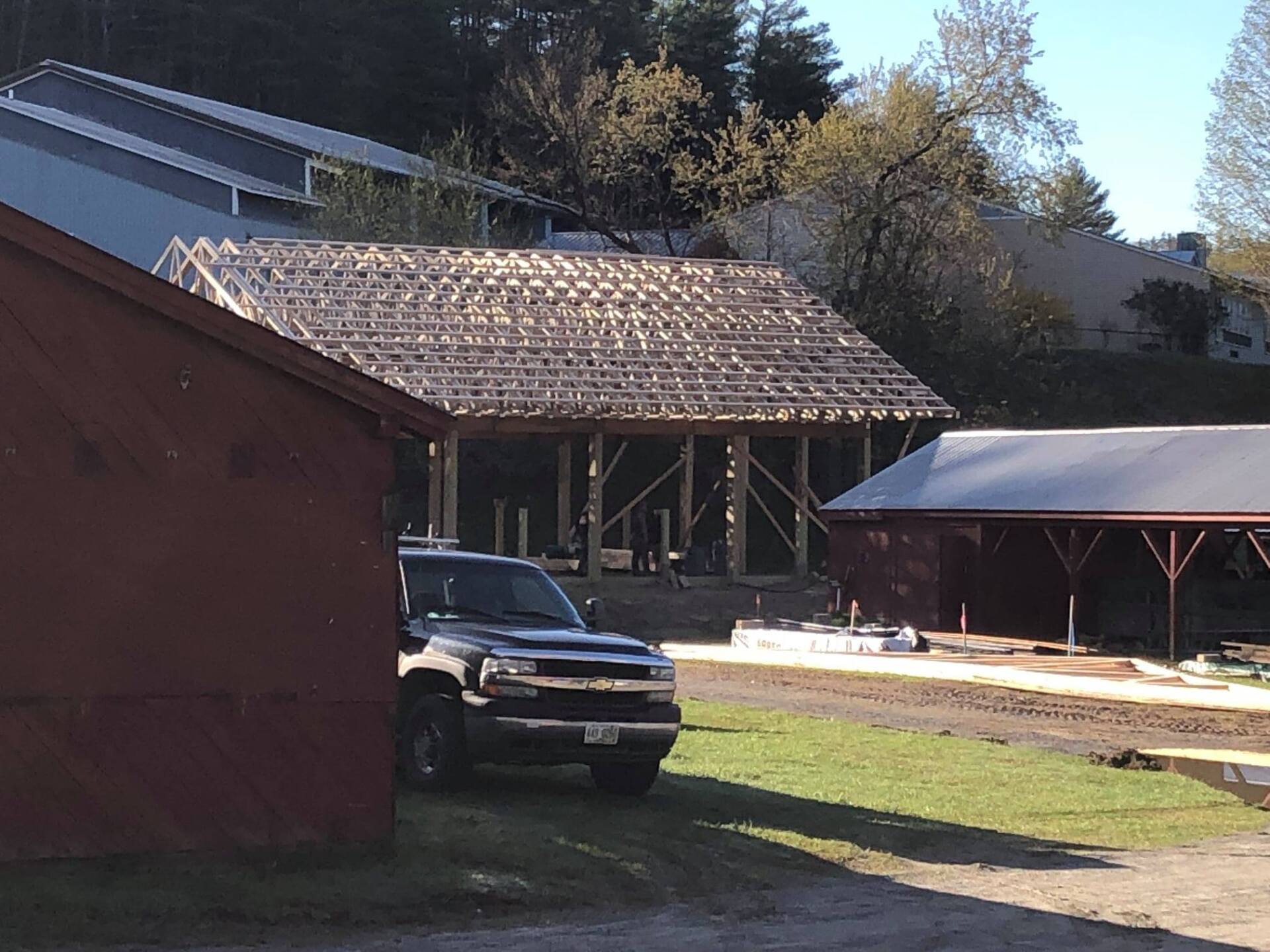 A truck is parked in front of a building under construction