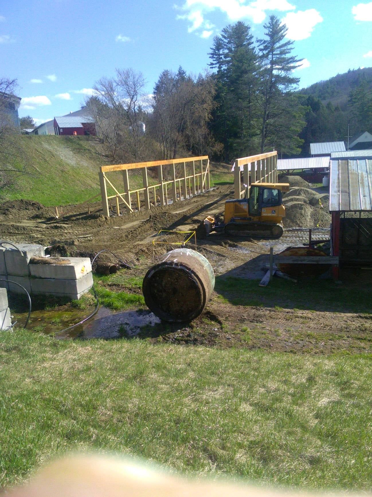 A large barrel is sitting in the middle of a construction site