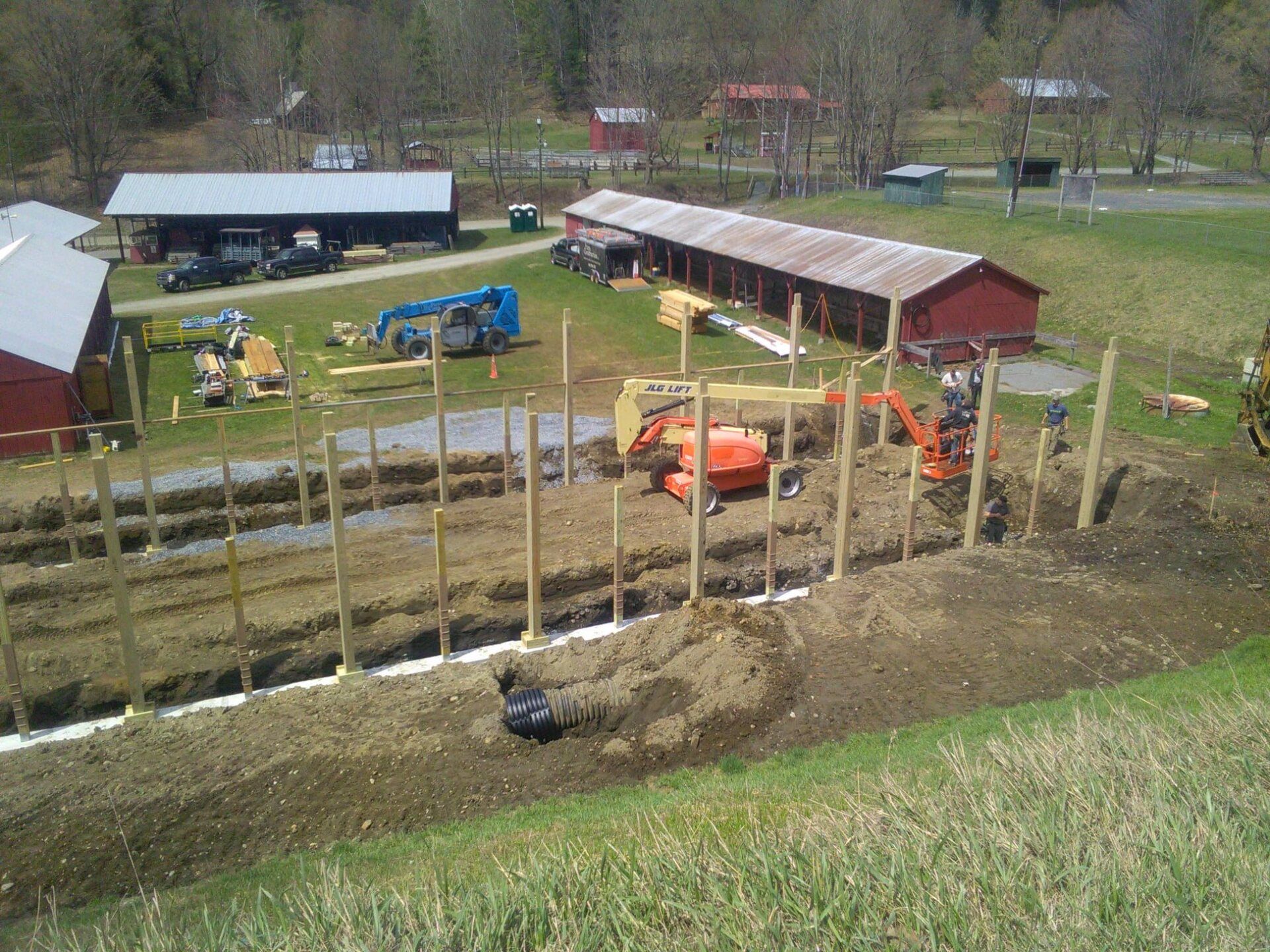 An aerial view of a farm with a fence being built