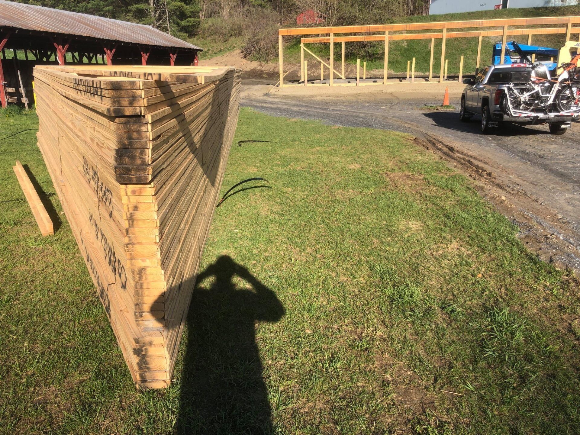 A large piece of wood is sitting on the grass next to a truck.