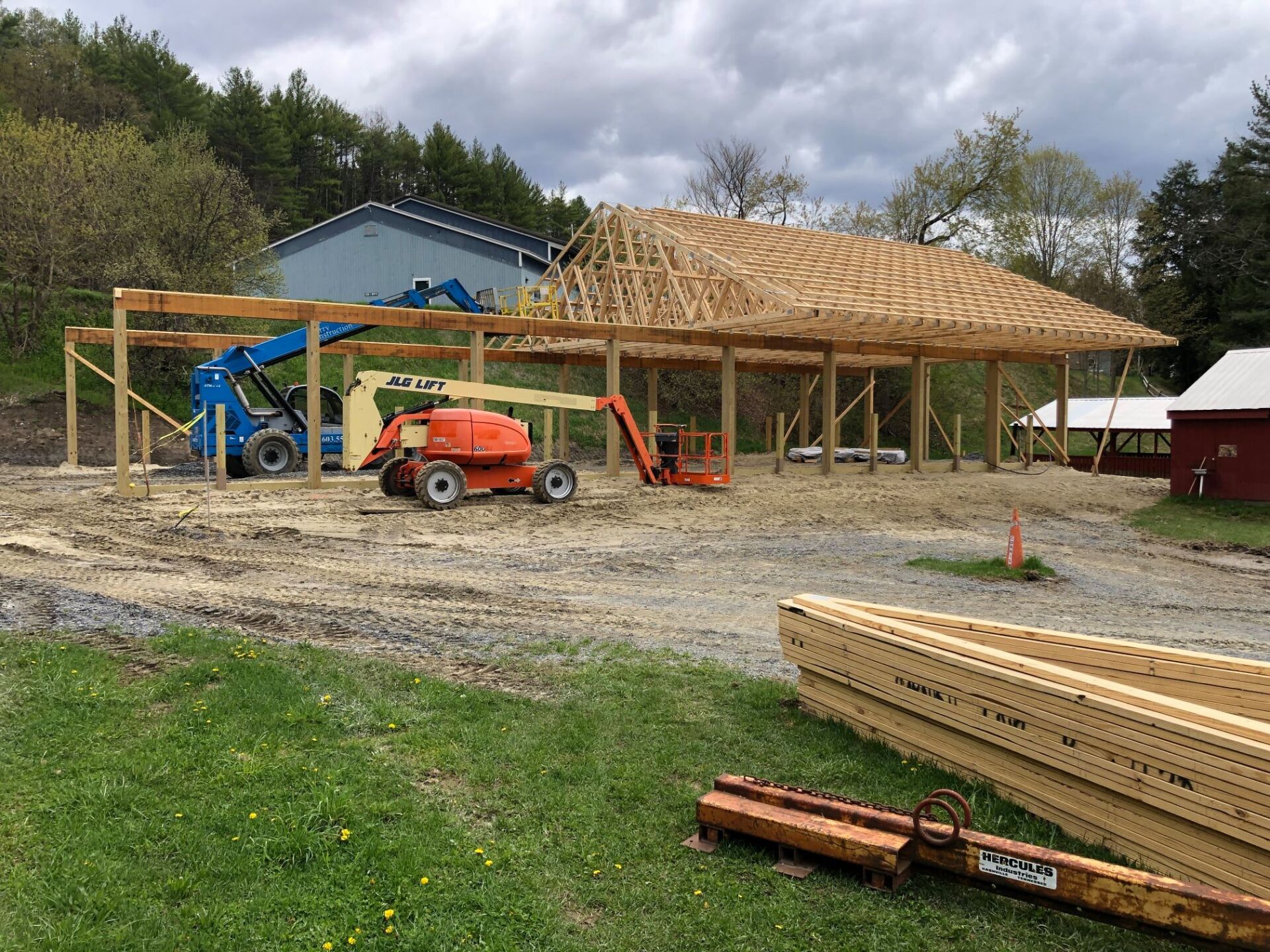 A building is being built in a field with a lot of machinery.