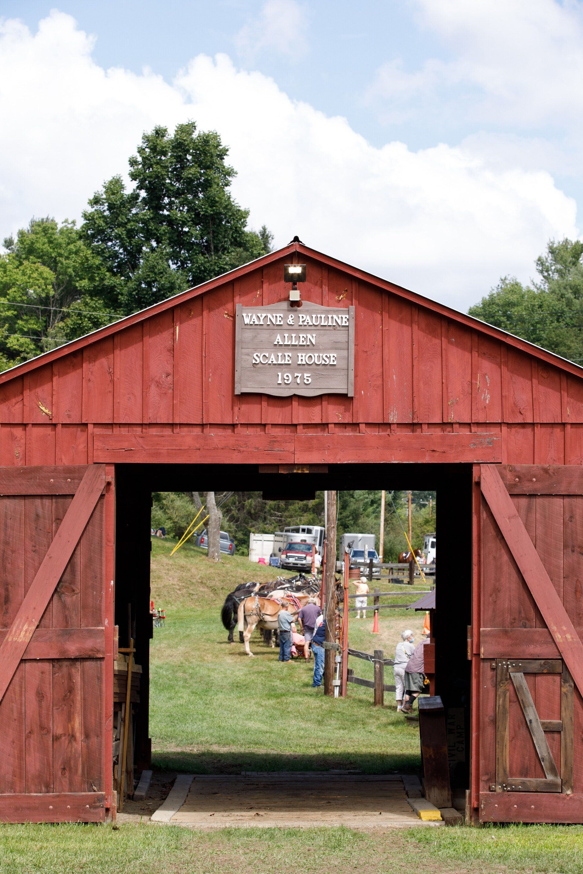 A red barn with a sign on the top of it that says ' liberty '