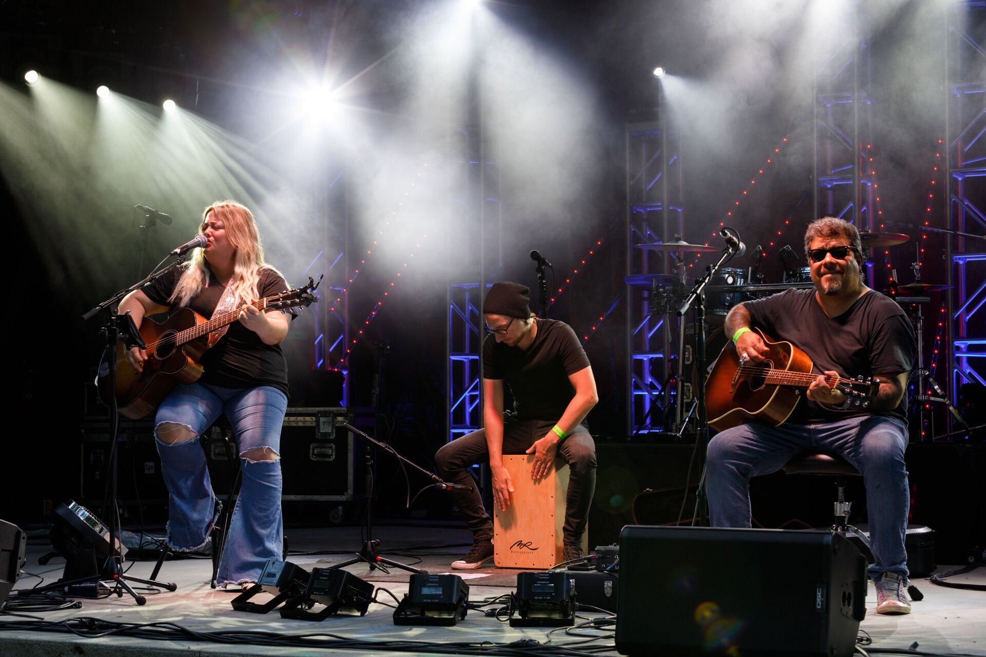 A group of people are playing guitars on a stage.