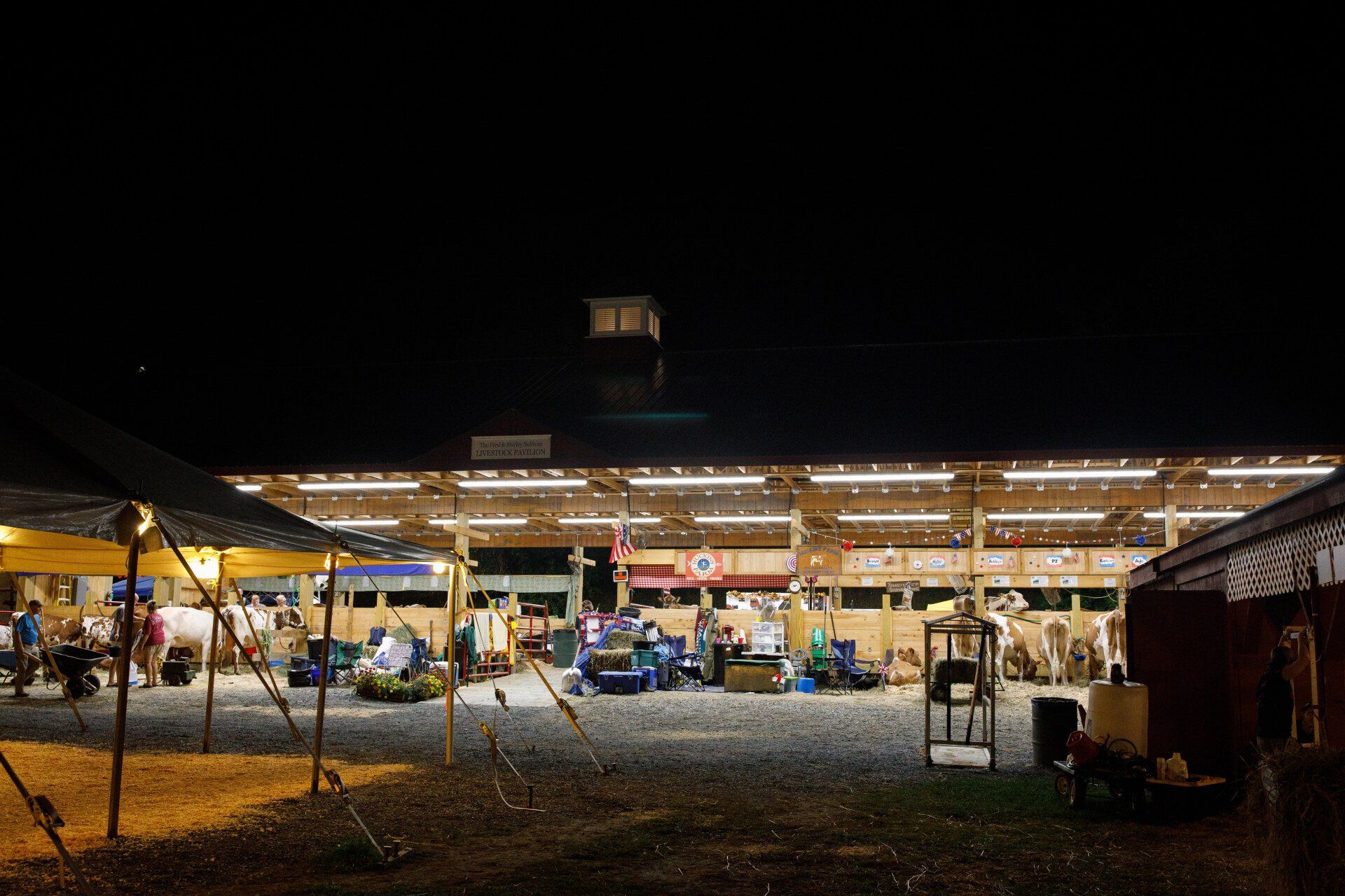 A large building with a lot of lights on it is lit up at night.