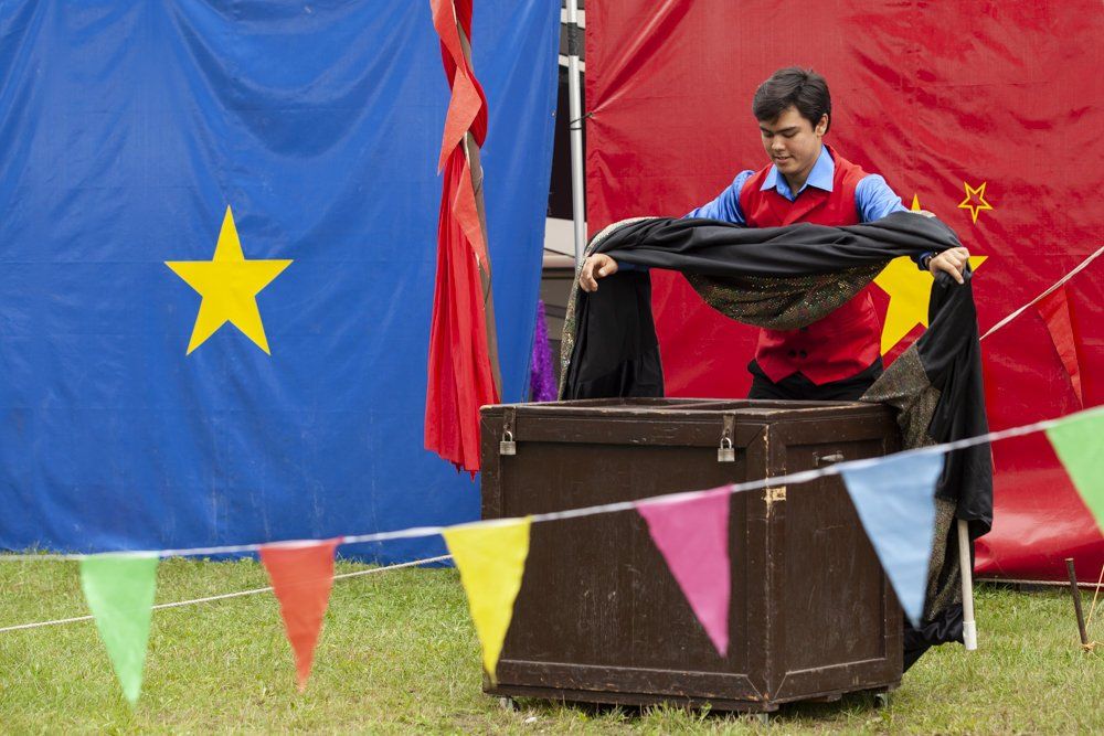 A man is standing in a box with a yellow star on it.