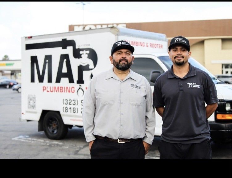 Two plumbers standing in front of a MAR Plumbing & Rooter service truck in a parking lot