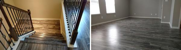 Stairway with wooden railing and dark wood floors leading into an empty room with gray walls and a window.