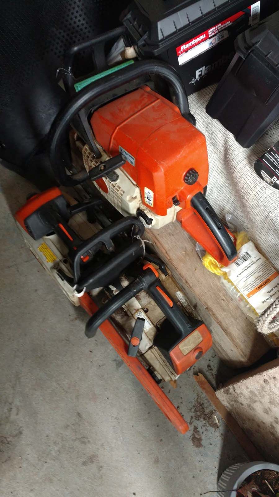 A chainsaw is sitting on top of a wooden table.
