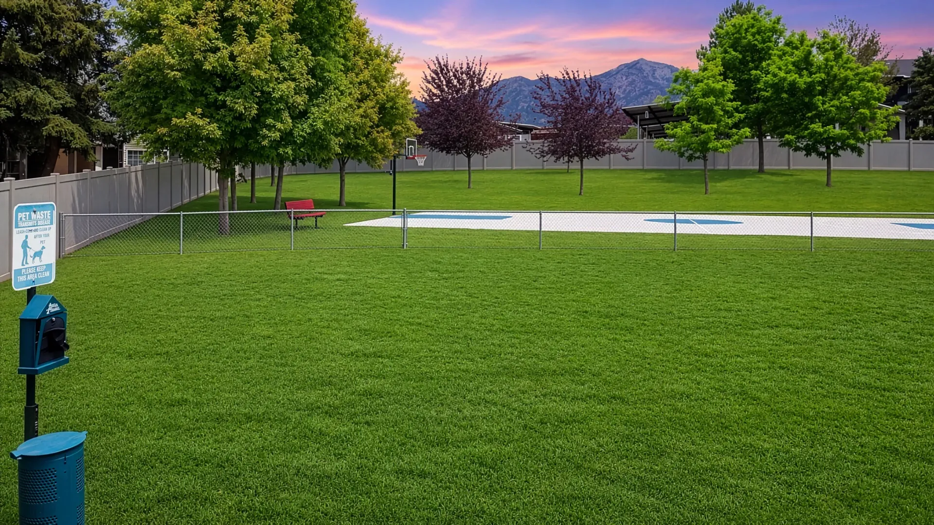 Dog park with a basketball hoop and bench at Mountain View Townhomes, offering townhomes in Ogden, UT.