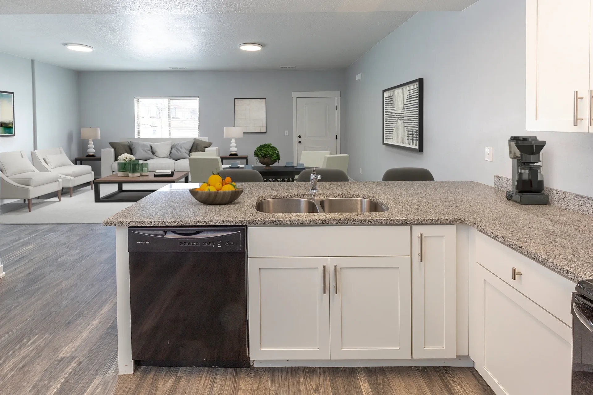Modern kitchen with granite countertops and stainless steel appliances at Mountain View Townhomes, offering townhomes in Ogden, UT.