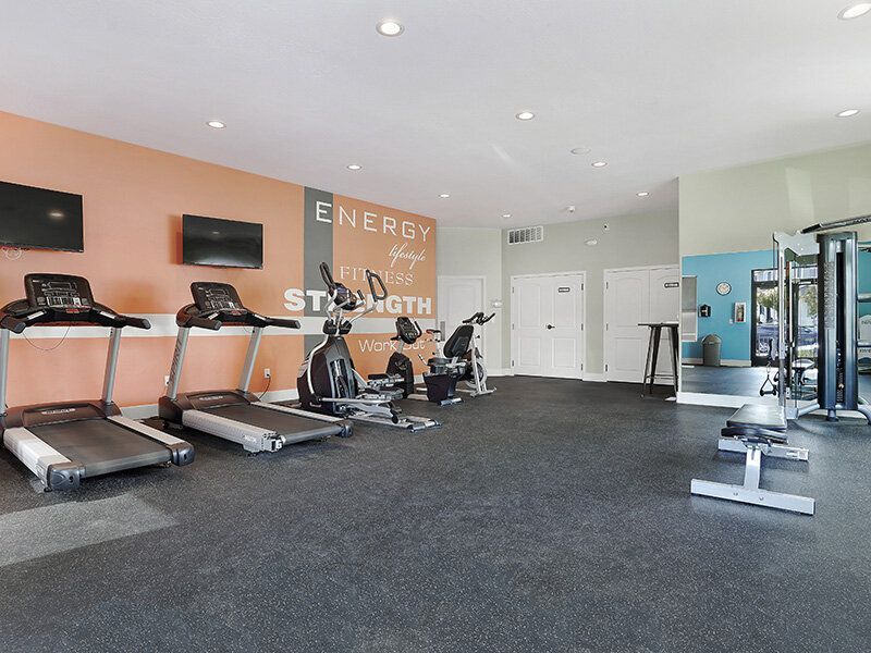Mountain View Townhomes community gym with treadmills, stationary bikes, and weight machines.