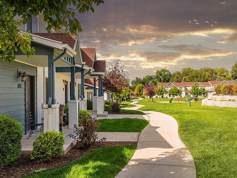 Mountain View Townhomes buildings with porches along a curved sidewalk.