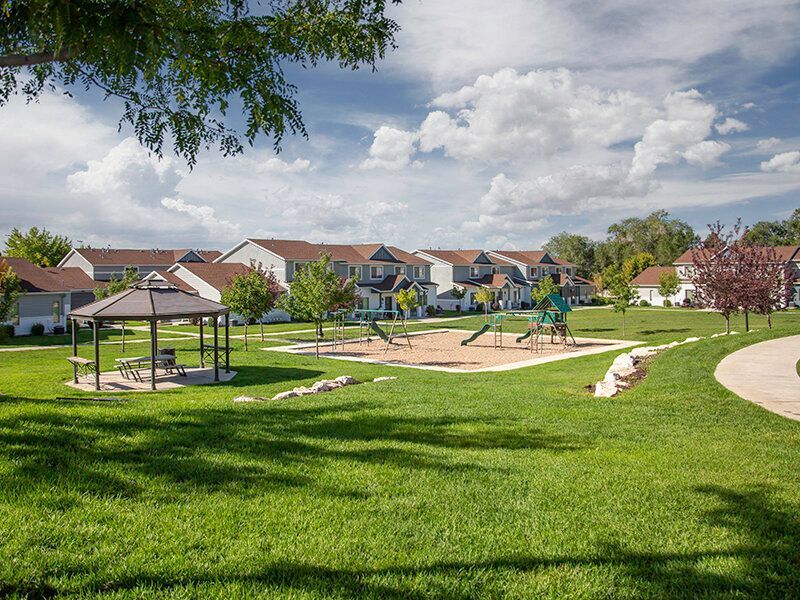 Mountain View Townhomes community lawn with a playground, gazebo, and walking path.