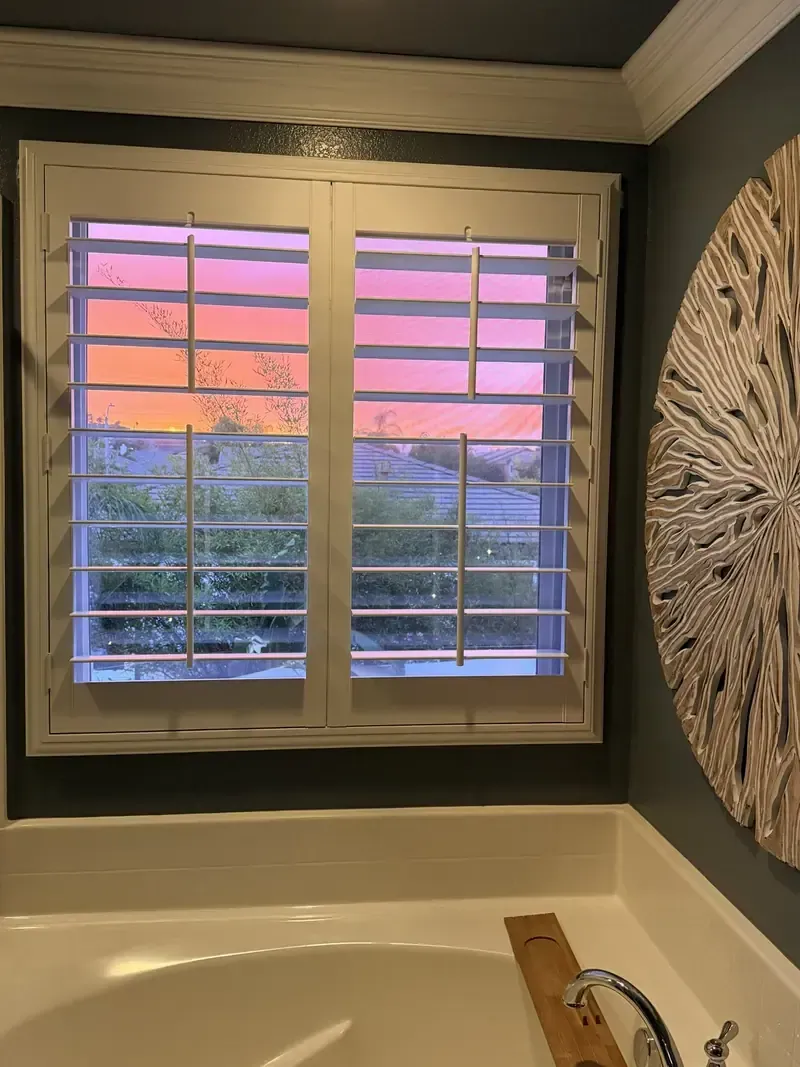 White plantation shutters installed over a bathroom window in a San Jacinto, CA home