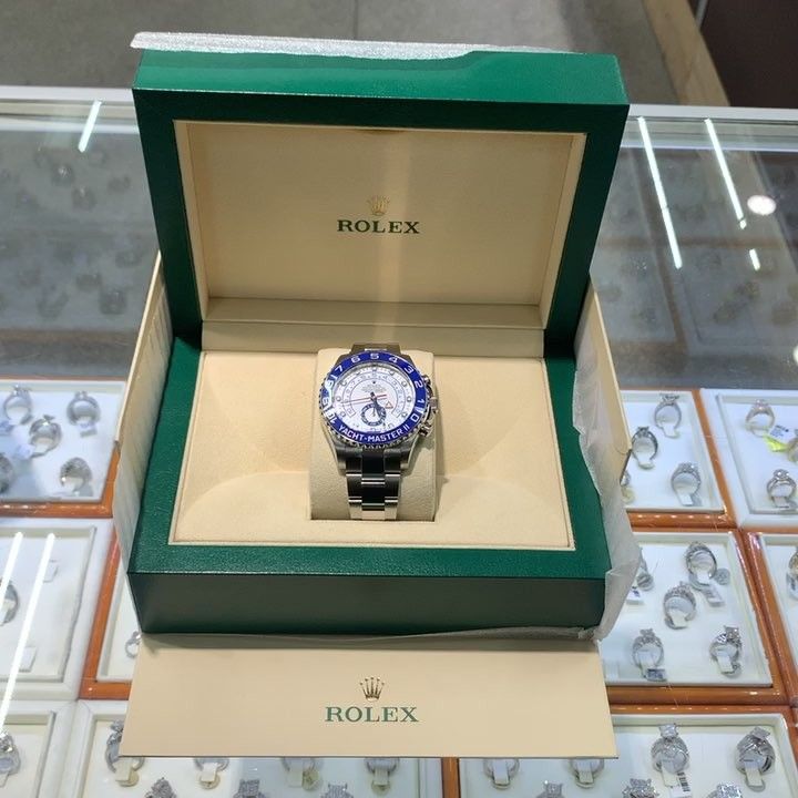Rolex watch in a green presentation box on a glass display counter