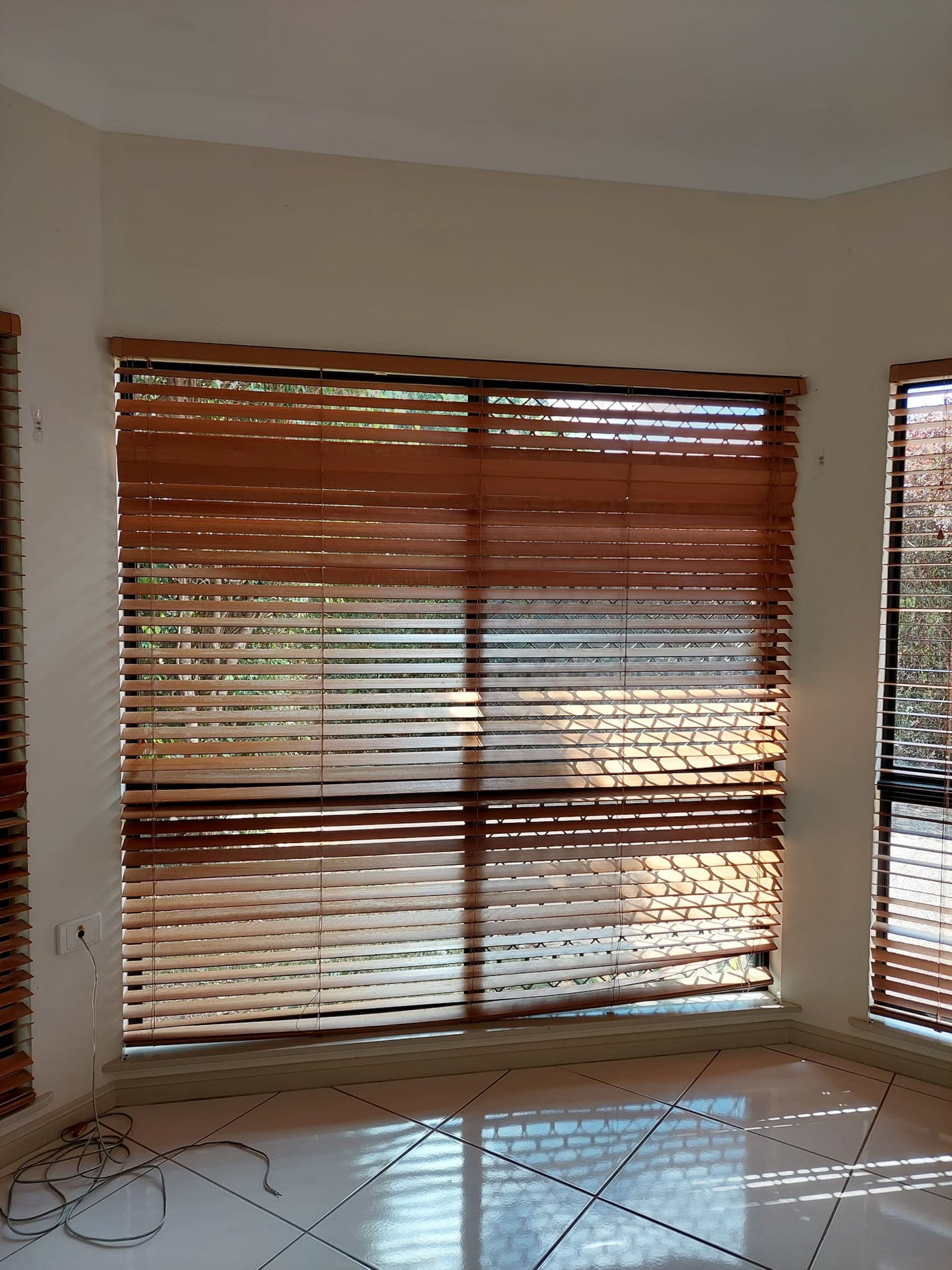 Brown Wooden Blinds on Windows in a Room — DAH Cleaning Services In Bungalow, QLD