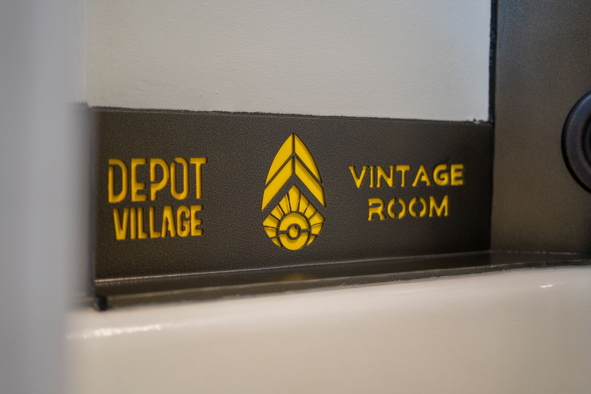 Black sign with yellow text: 